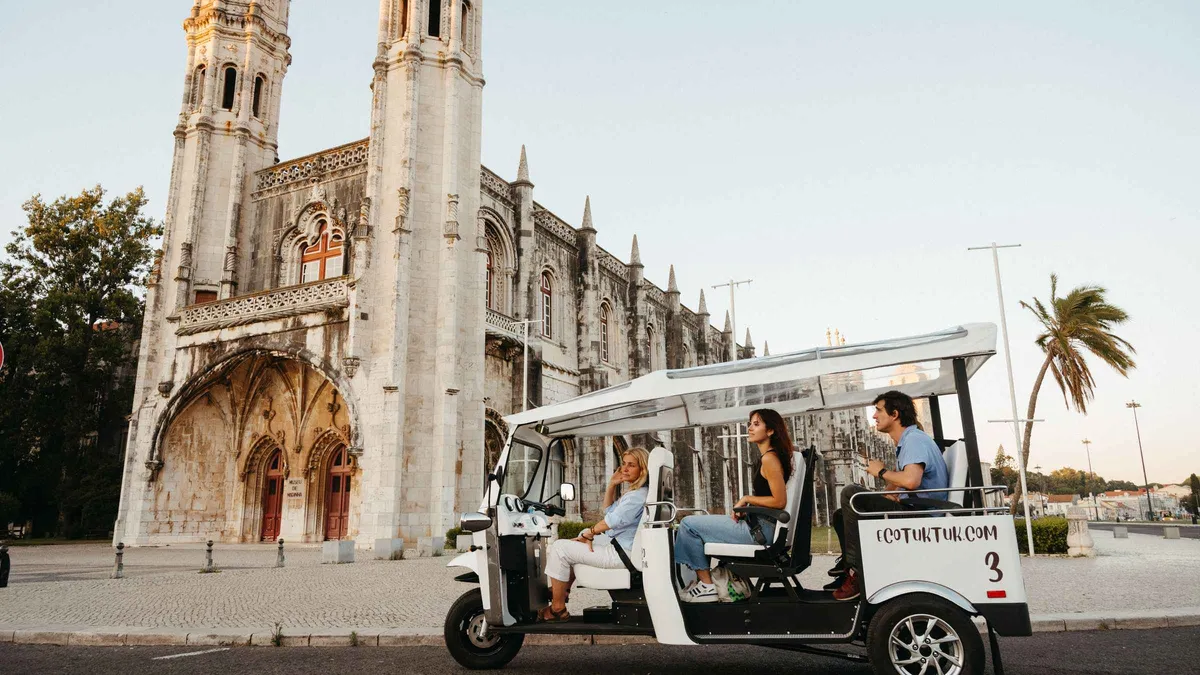 Electric tuk-tuk parked at a Lisbon viewpoint on a private eco tuk-tuk city tour of Lisbon