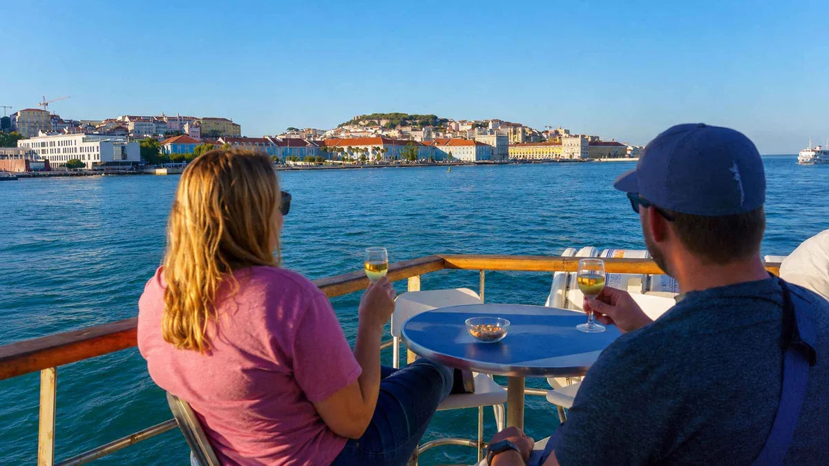The 25 de Abril bridge and Cristo Rei seen from a ferry on the Tagus, day two of a Lisbon in 2 days itinerary